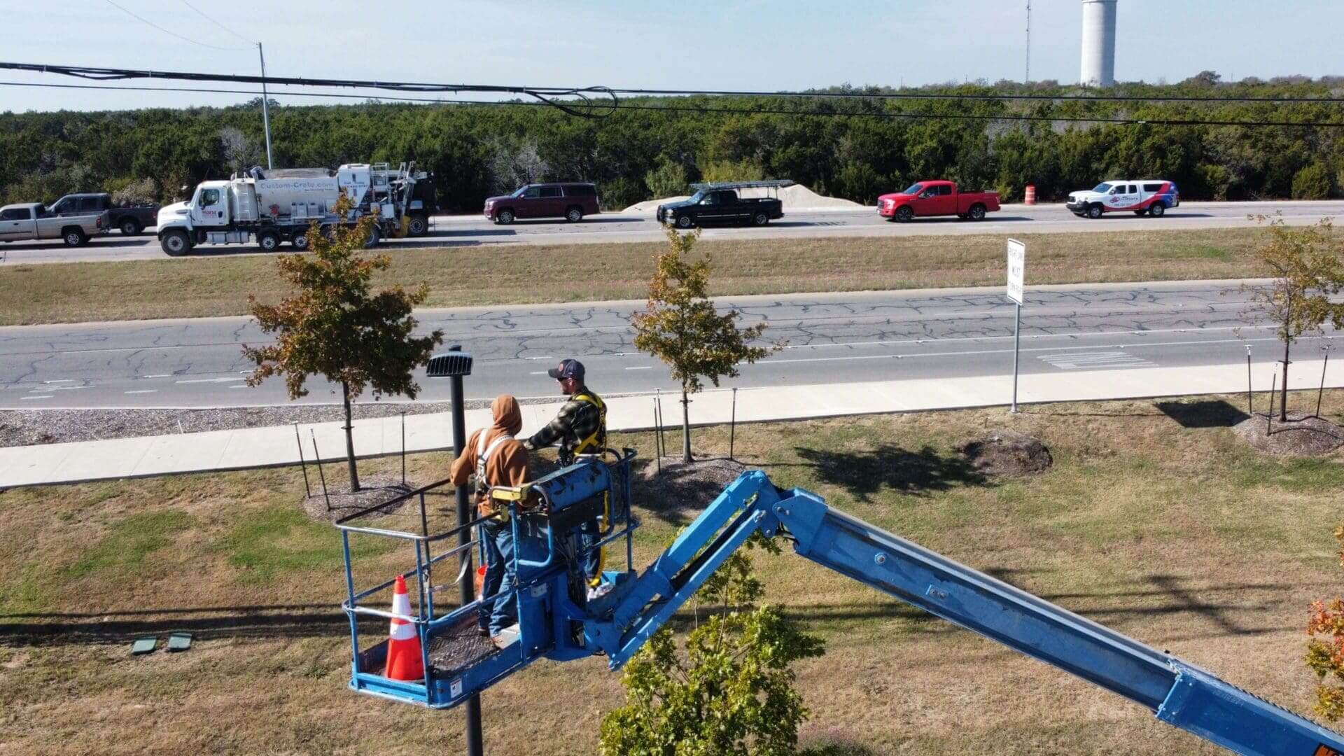 DJ Electric Inc electricians in central texas working on a boom lift